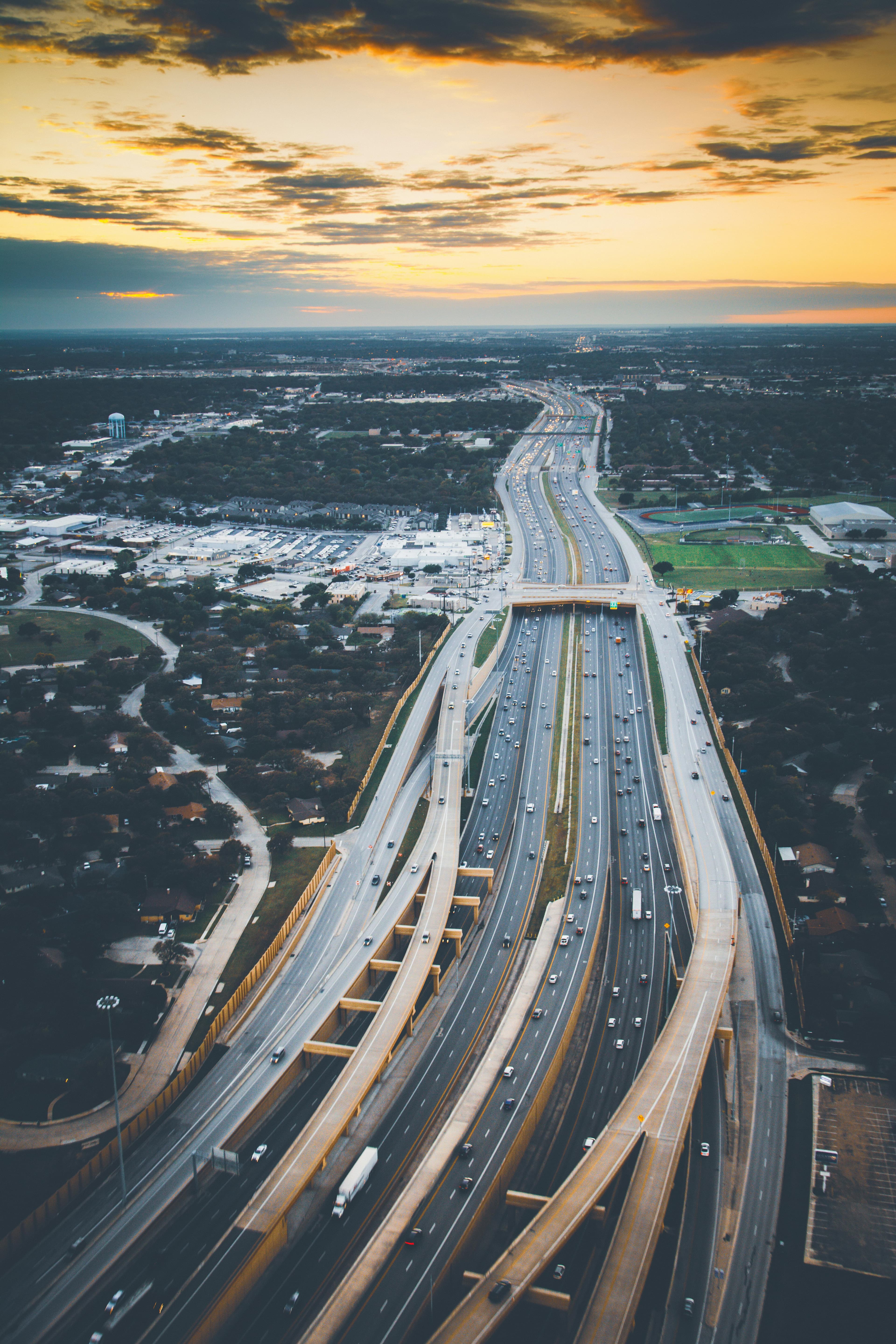 Aerial view of a multilane highway at sunset.